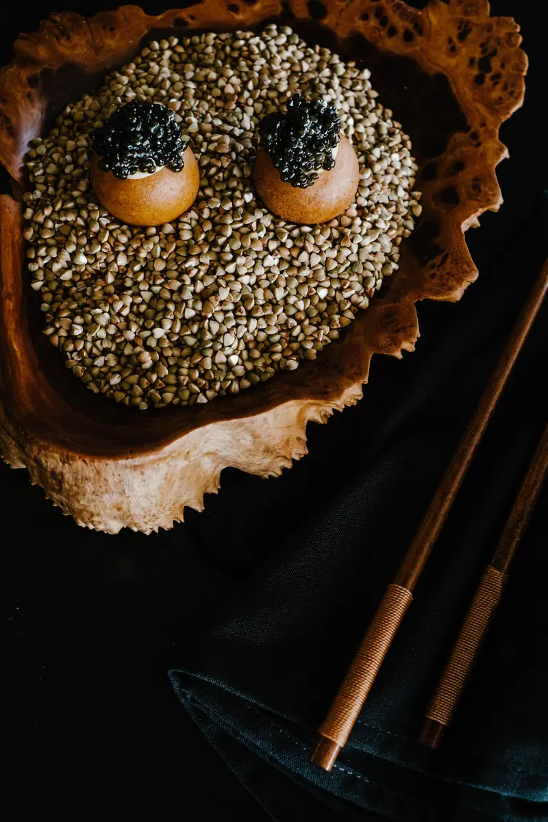 A caviar dish from above on a dark background
