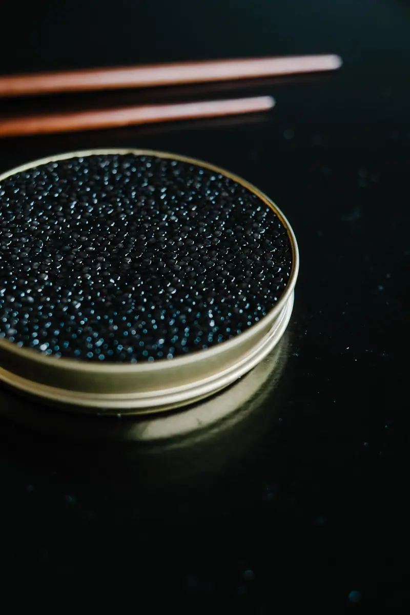 A metal tin filled with black caviar